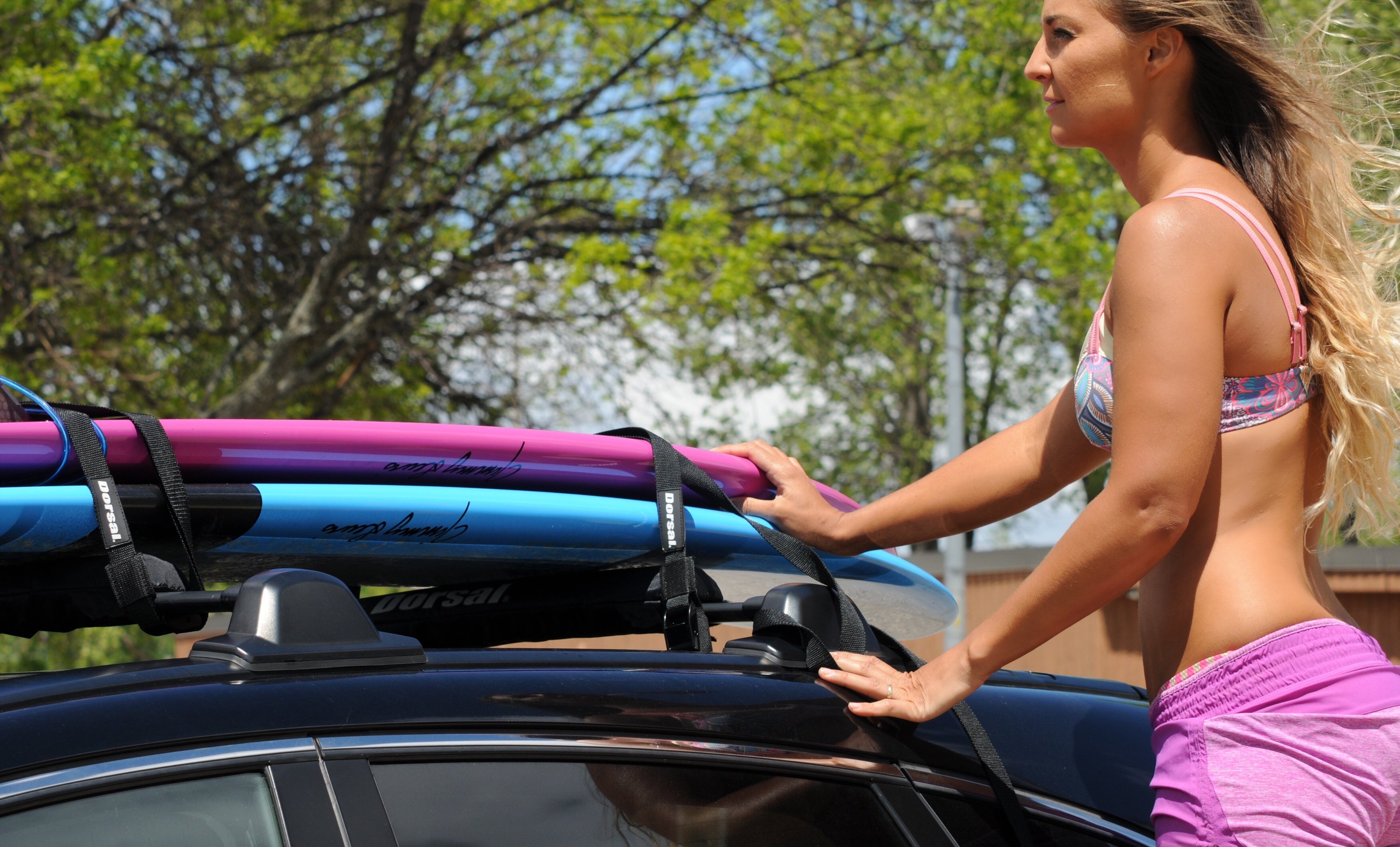 DORSAL SunGuard Aero Roof Rack Pads designed for secure transport of surfboards and paddle boards, featuring durable EVA foam and weatherproof nylon sleeve.