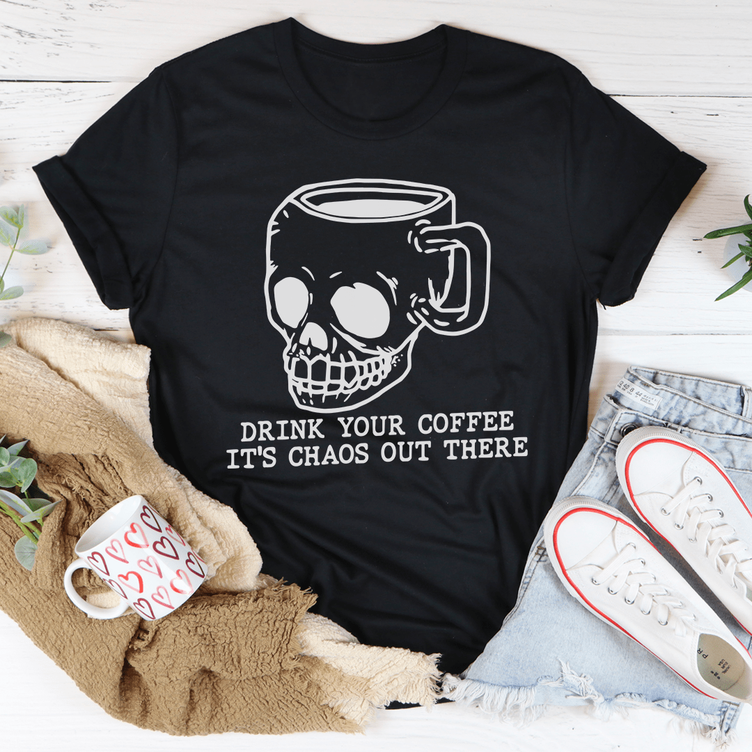 A stylish t-shirt featuring the phrase 'Drink Your Coffee It's Chaos Out There', made from soft ring-spun cotton with double stitching.