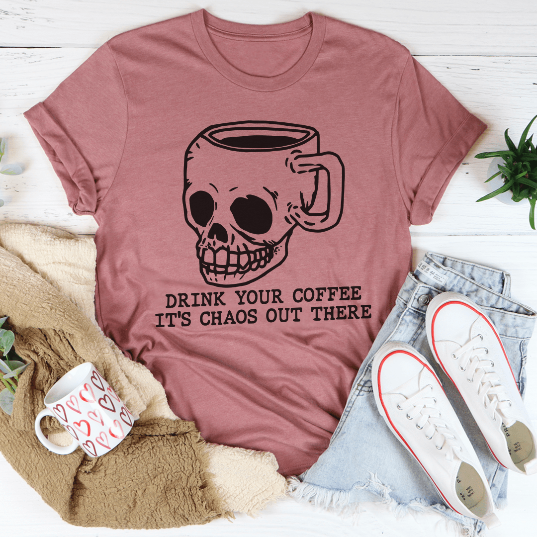 A stylish t-shirt featuring the phrase 'Drink Your Coffee It's Chaos Out There', made from soft ring-spun cotton with double stitching.