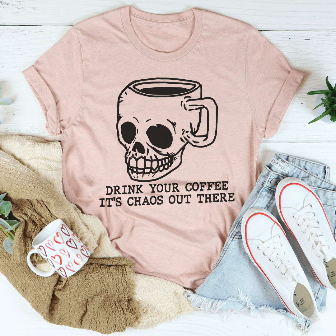 A stylish t-shirt featuring the phrase 'Drink Your Coffee It's Chaos Out There', made from soft ring-spun cotton with double stitching.