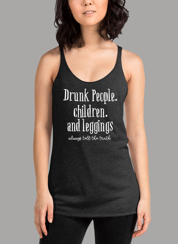 White women's tank top with racerback design and curved hem, featuring the text 'Drunk People Children And Leggings'.