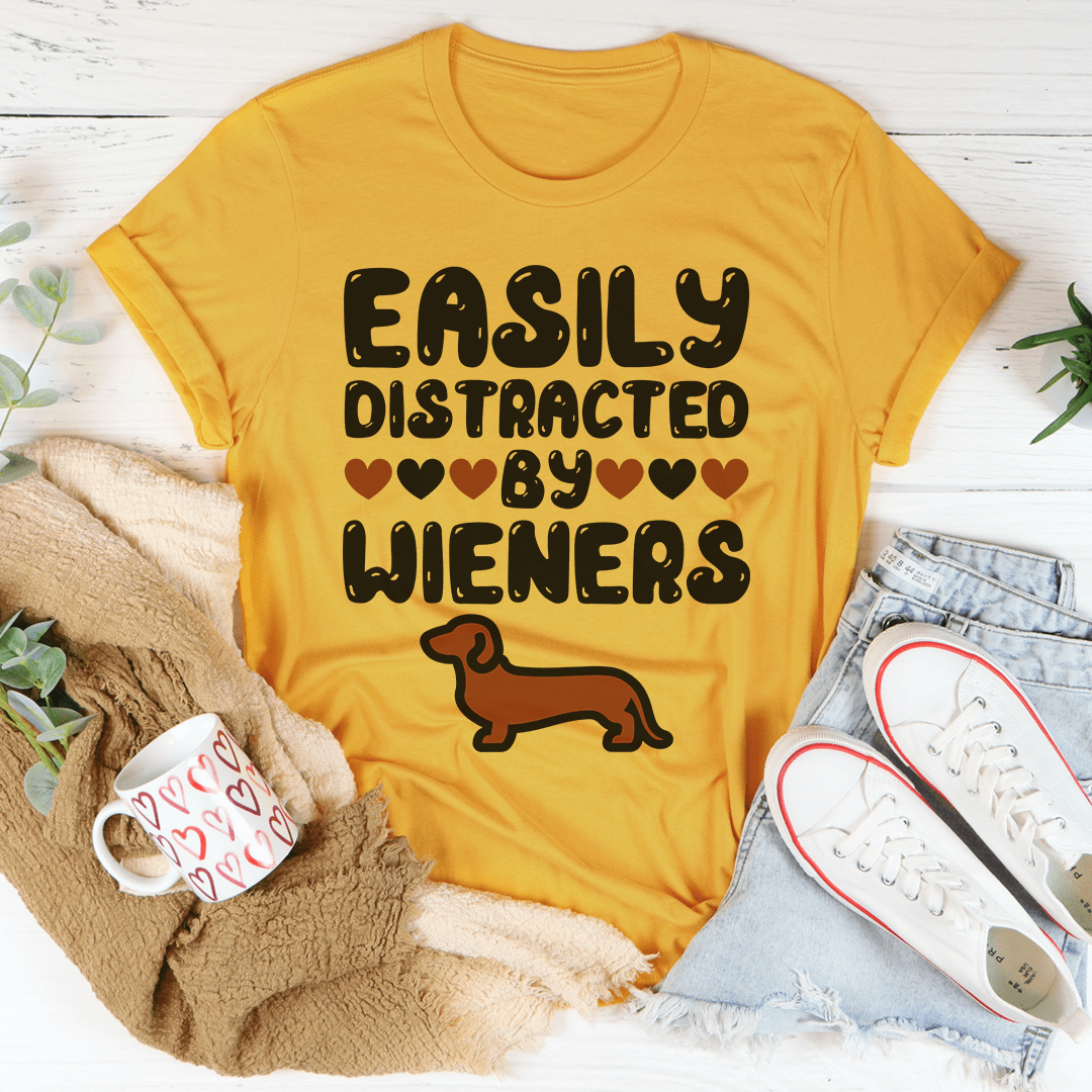 Easily Distracted By Wieners Tee featuring a playful design on a soft cotton fabric, perfect for casual wear.