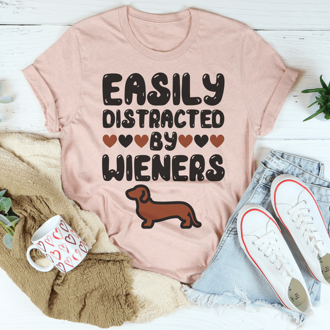 Easily Distracted By Wieners Tee featuring a playful design on a soft cotton fabric, perfect for casual wear.