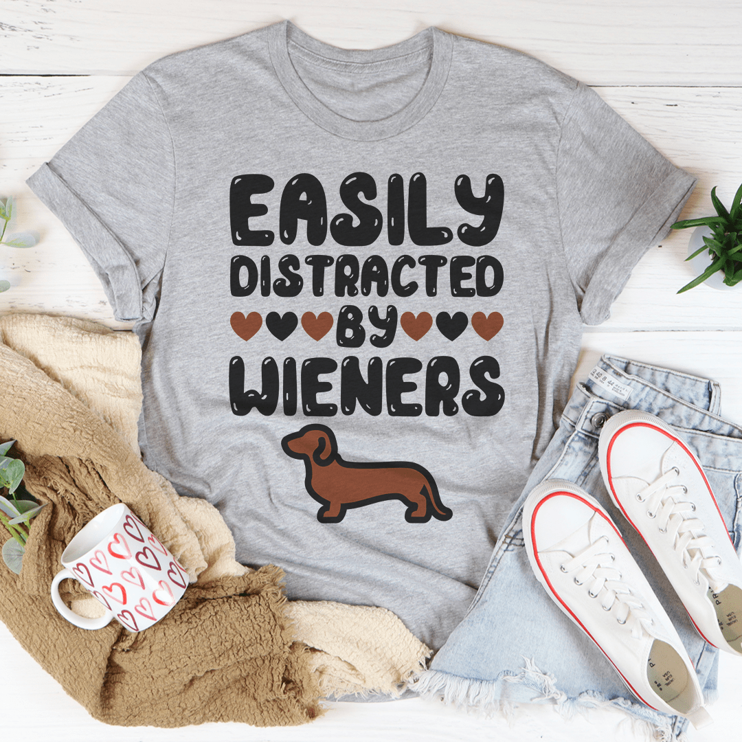 Easily Distracted By Wieners Tee featuring a playful design on a soft cotton fabric, perfect for casual wear.