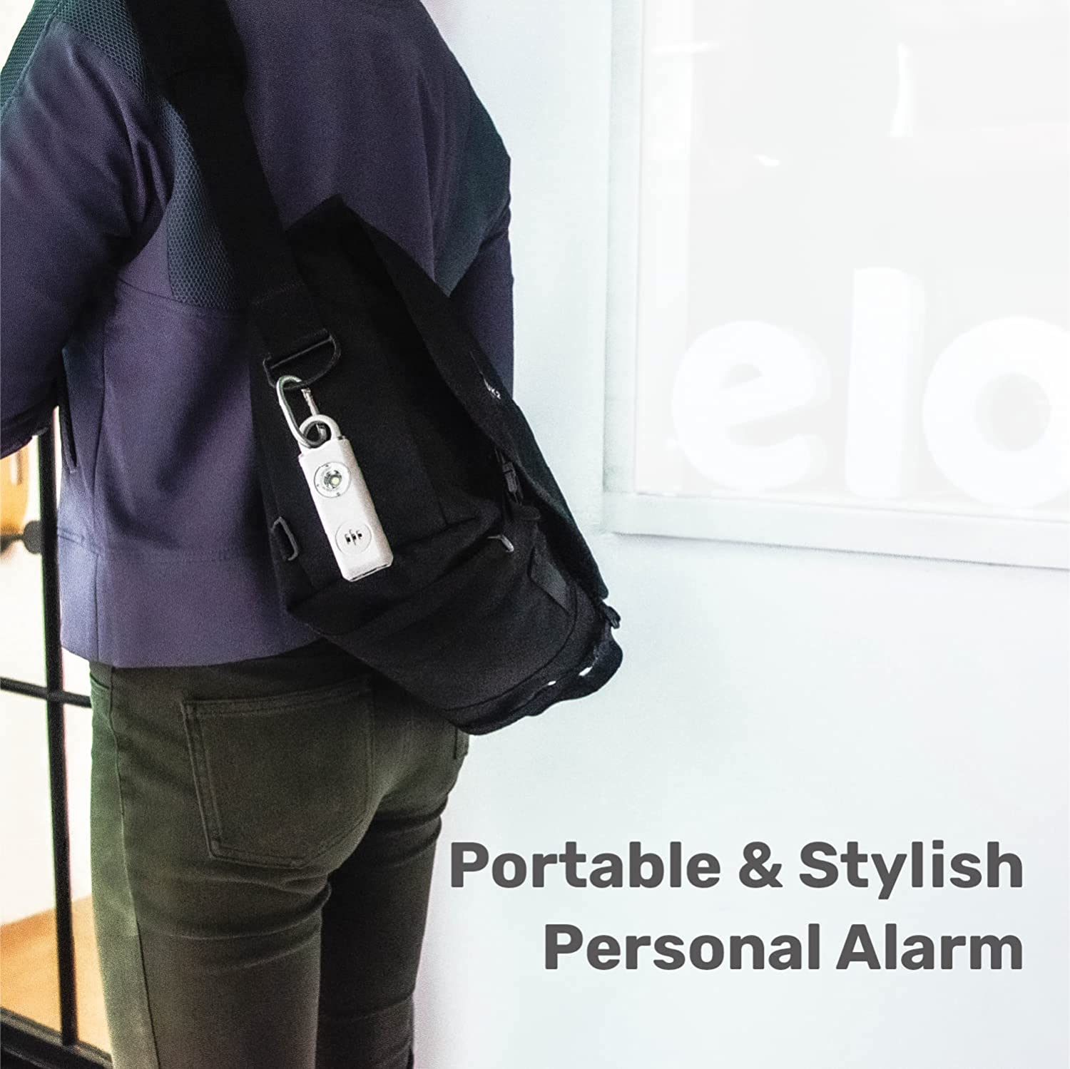 Elos Personal Alarm in Smoky Black, a compact safety device with LED light and keychain attachment.