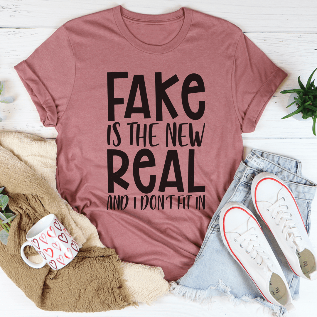 A stylish and comfortable Fake Is The New Real Tee made from soft ring-spun cotton, featuring double stitching for durability.