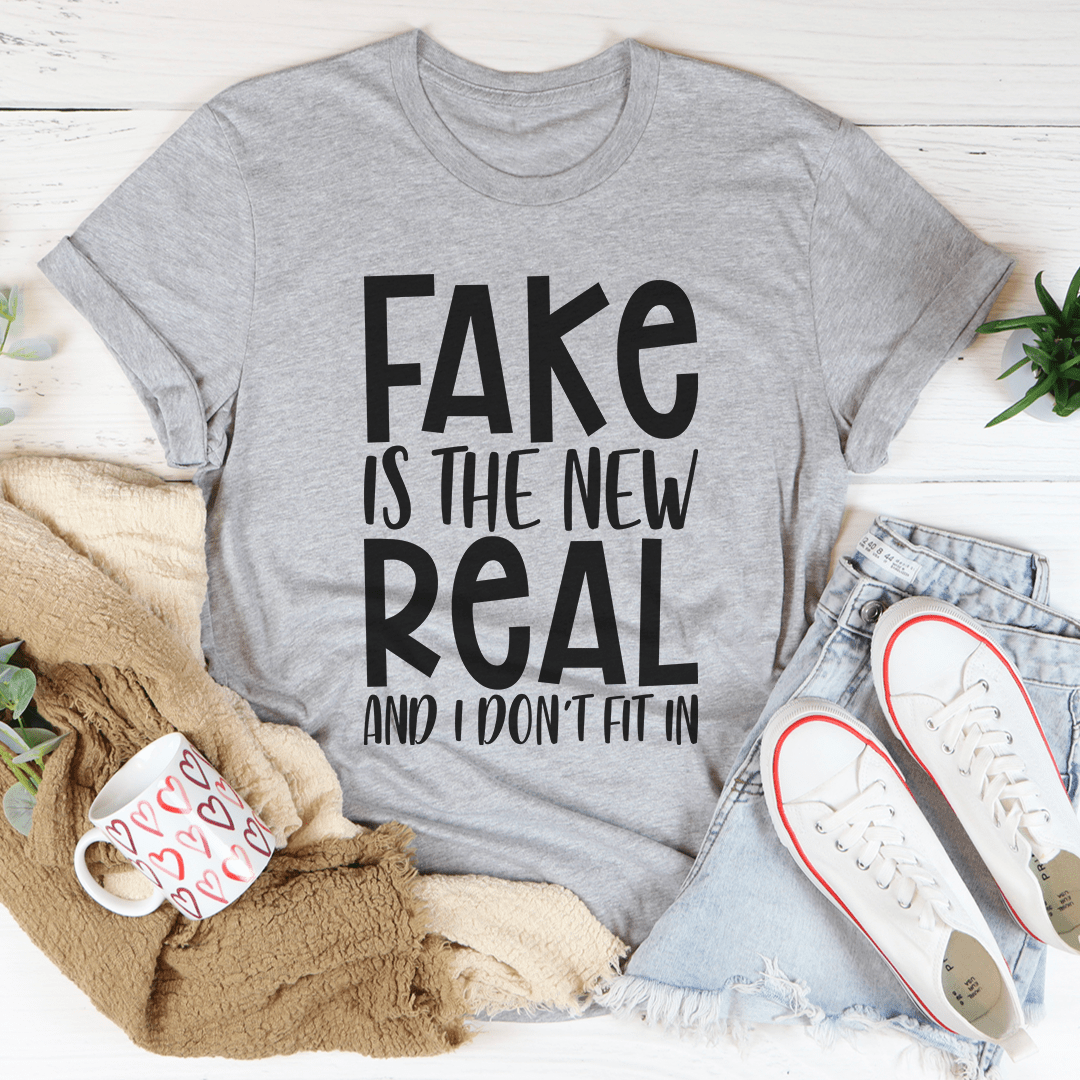 A stylish and comfortable Fake Is The New Real Tee made from soft ring-spun cotton, featuring double stitching for durability.