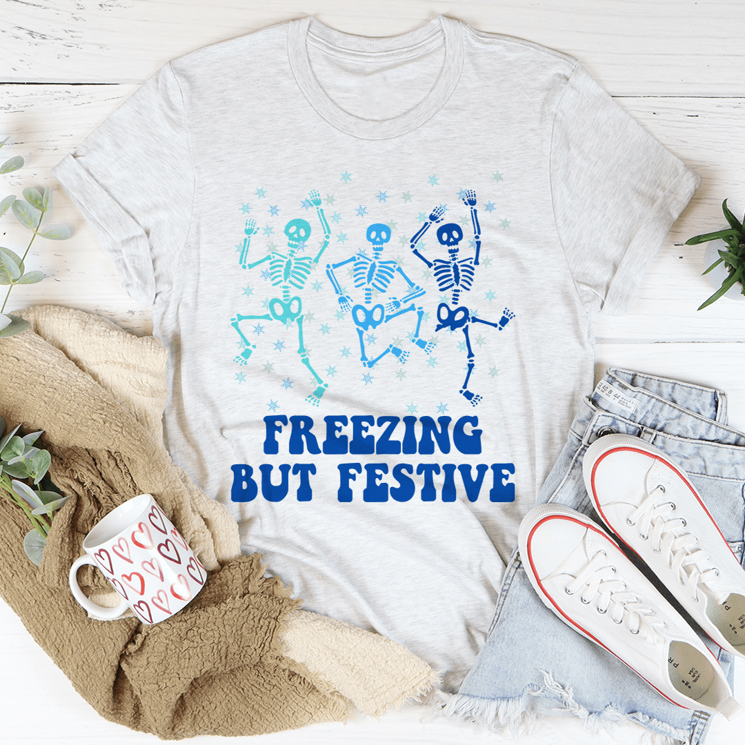 A cozy Freezing But Festive Tee made of soft ring-spun cotton, featuring double stitching for durability, displayed in a festive setting.