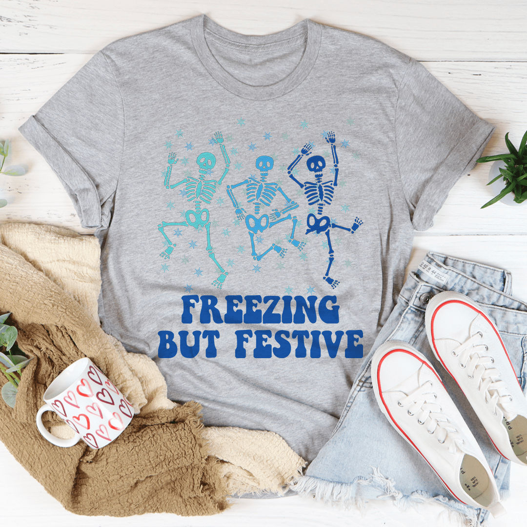 A cozy Freezing But Festive Tee made of soft ring-spun cotton, featuring double stitching for durability, displayed in a festive setting.