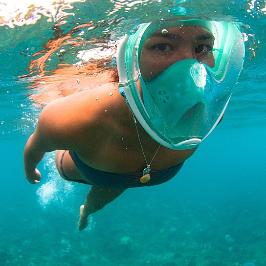 A full face snorkel mask with a transparent visor, designed for 180-degree views, featuring adjustable straps and a ventilated storage bag.