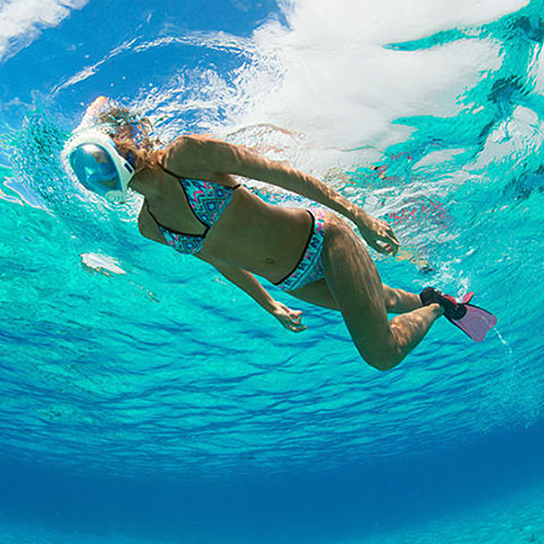 A full face snorkel mask with a transparent visor, designed for 180-degree views, featuring adjustable straps and a ventilated storage bag.