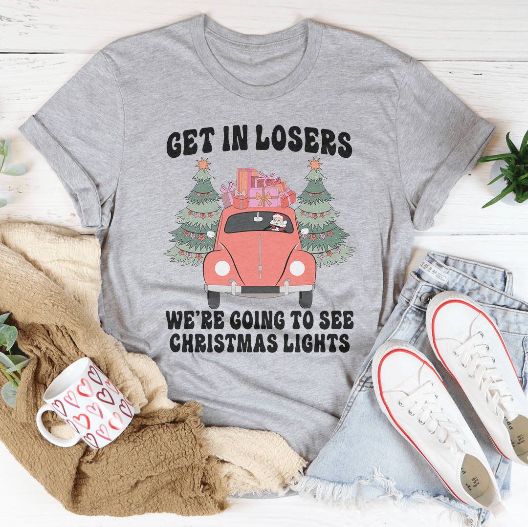 A festive t-shirt featuring the phrase 'Get In Losers We're Going To See Christmas Lights', made from soft cotton with double stitching.