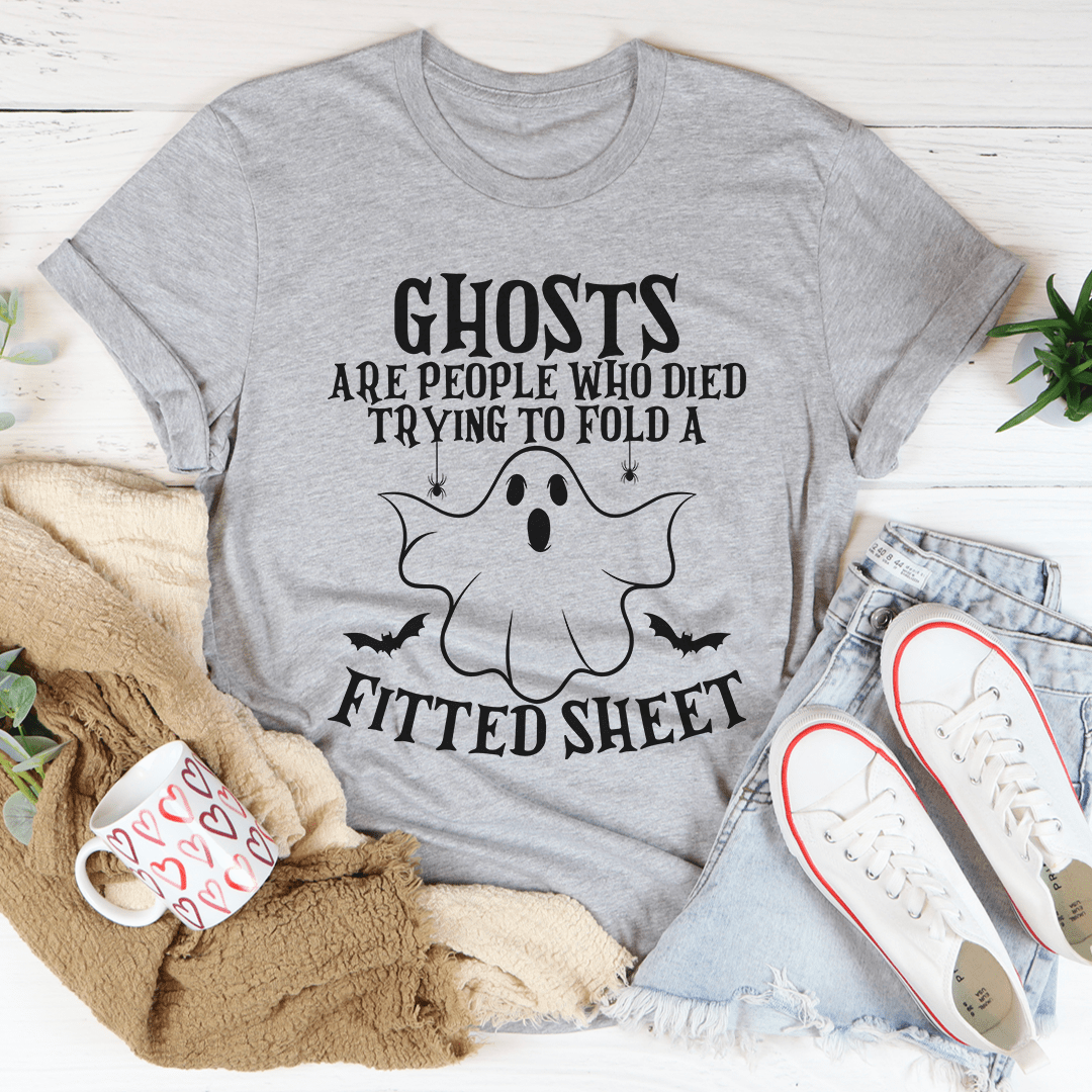 A comfortable t-shirt featuring the phrase 'Ghosts Are For People Who Tried To Fold A Fitted Sheet', made from soft ring-spun cotton.