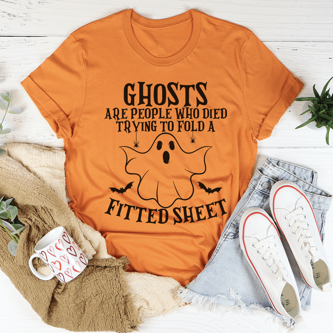 A comfortable t-shirt featuring the phrase 'Ghosts Are For People Who Tried To Fold A Fitted Sheet', made from soft ring-spun cotton.