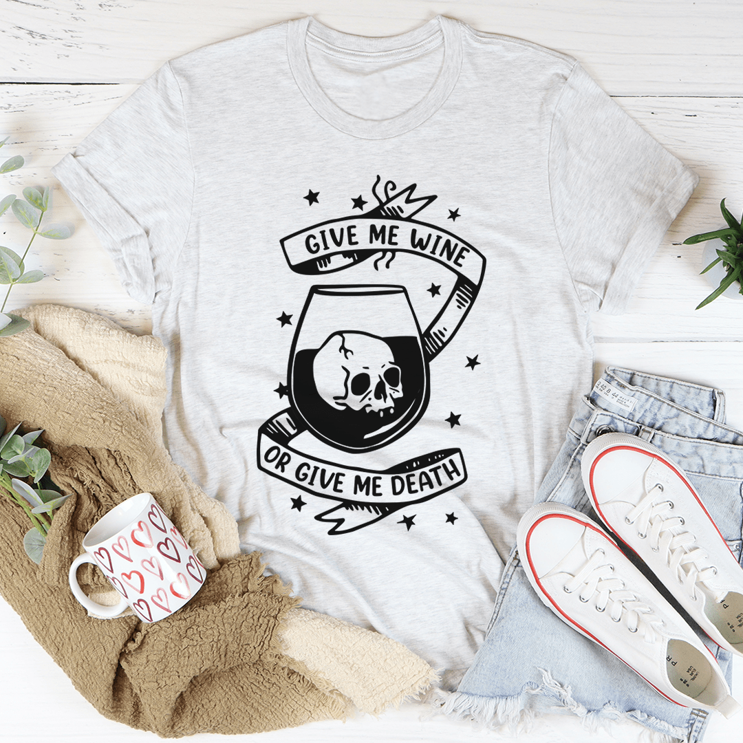 A black t-shirt featuring the phrase 'Give Me Wine Or Give Me Death' in bold white lettering, showcasing a stylish and humorous design.