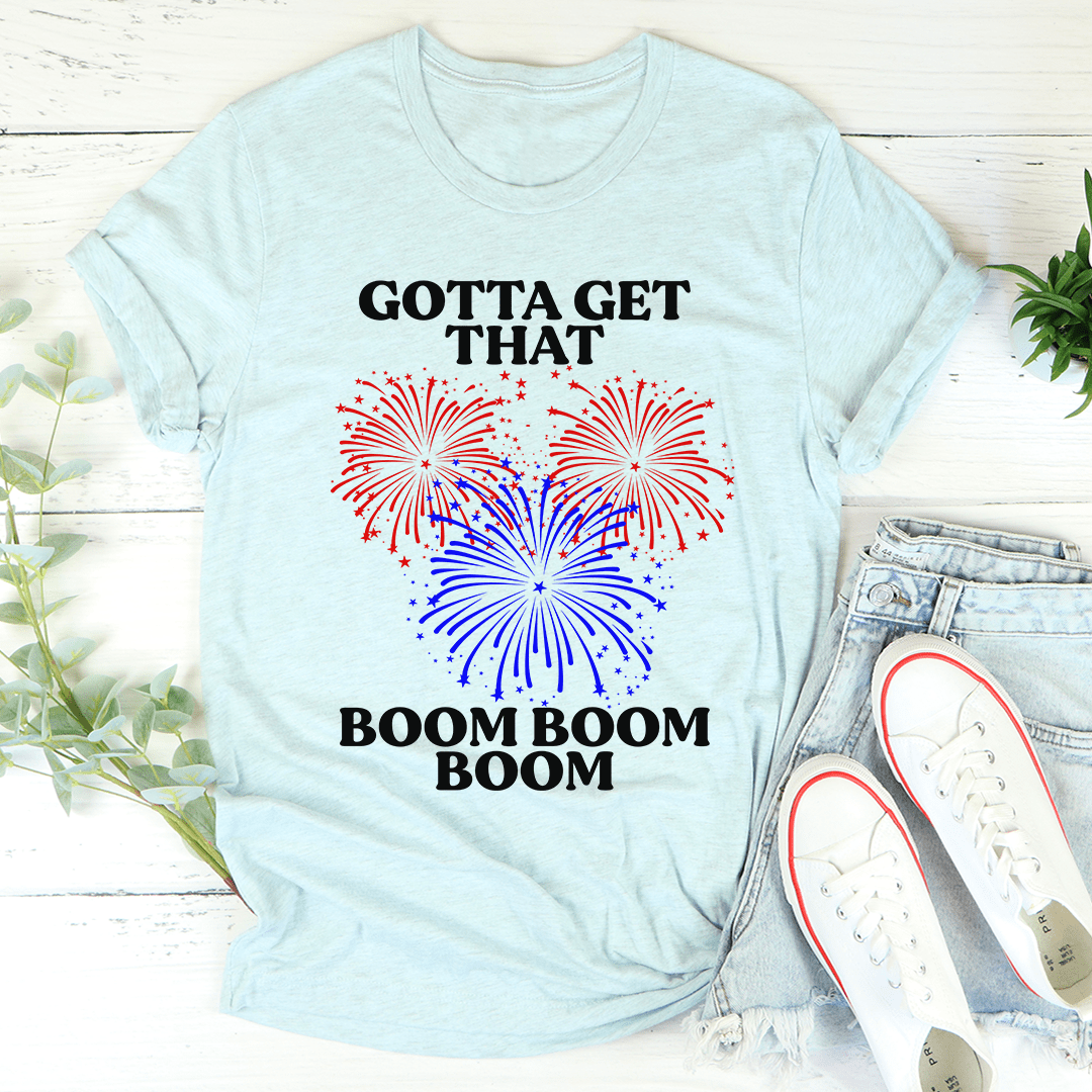 Gotta Get That Boom Boom Boom Tee in various colors, showcasing its soft fabric and double stitching details.