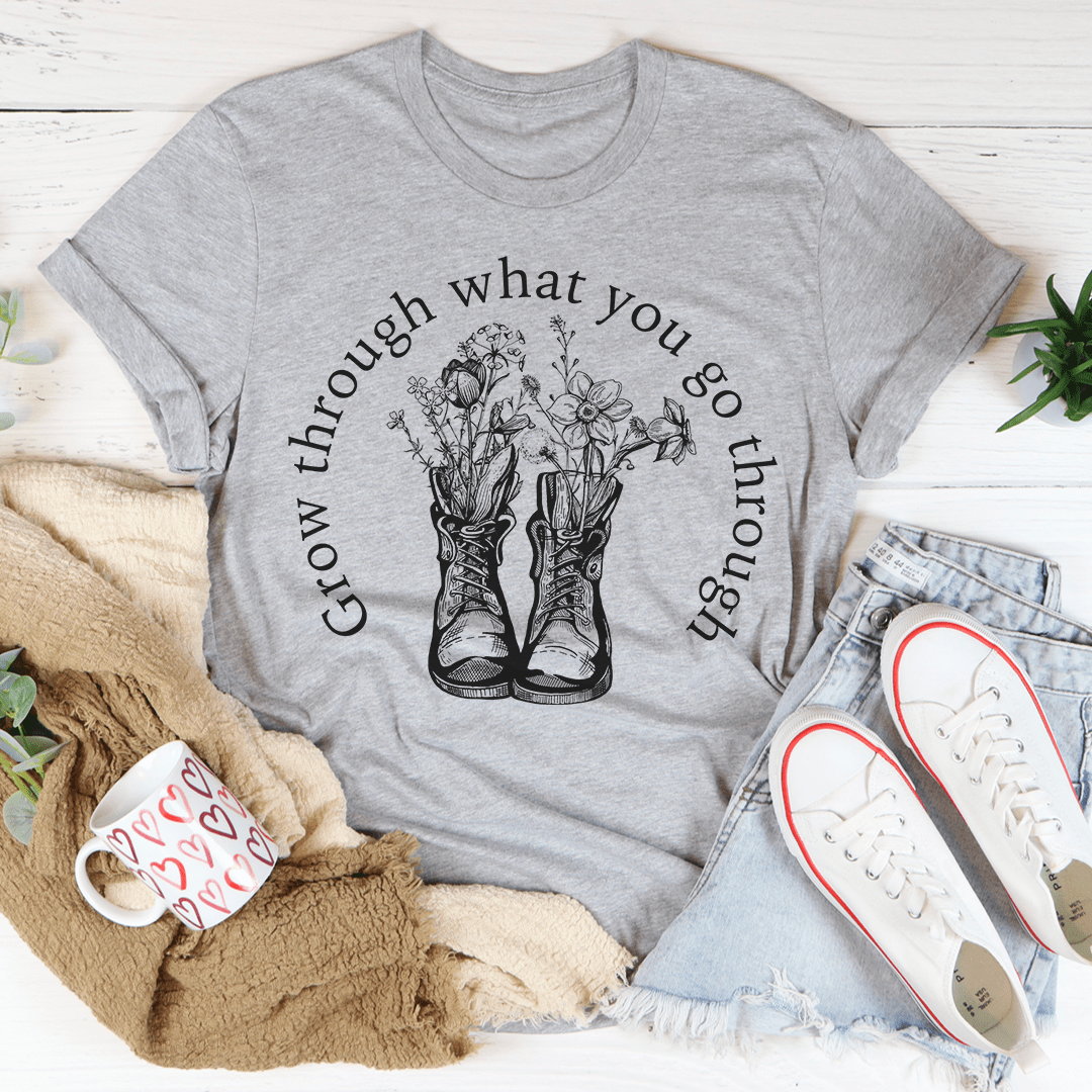 A stylish Grow Through What You Go Through Boots Tee made of soft ring-spun cotton, featuring double stitching for durability.