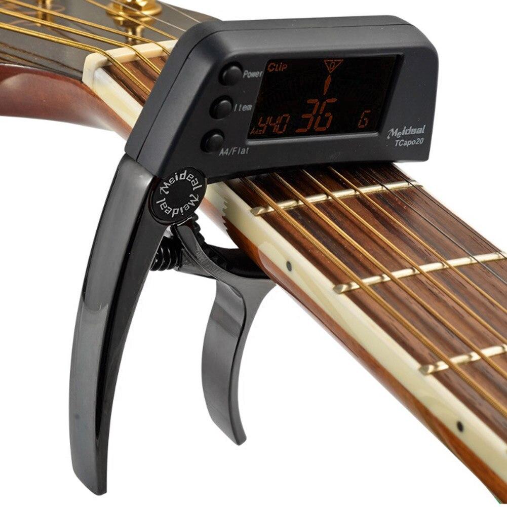 Guitar Tuner Capo 2 in 1, a compact device for tuning and capo functionality, suitable for guitar, bass, and violin.