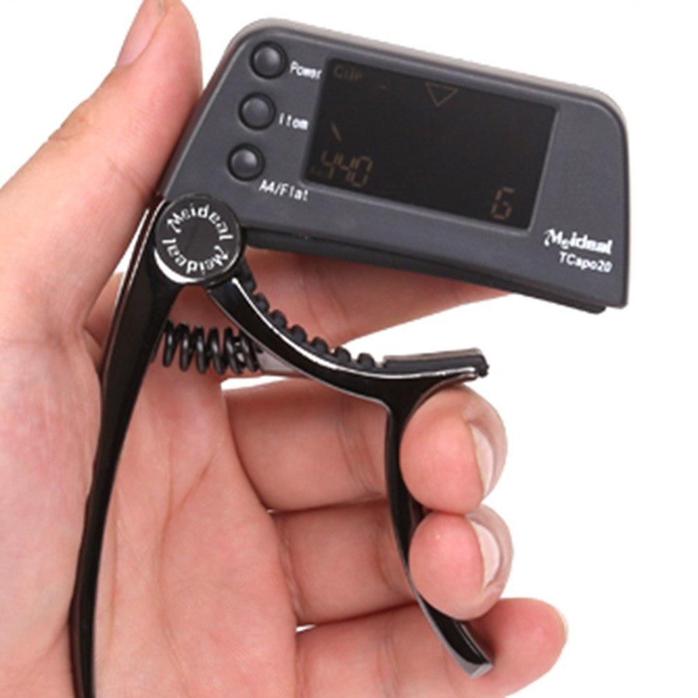 Guitar Tuner Capo 2 in 1, a compact device for tuning and capo functionality, suitable for guitar, bass, and violin.