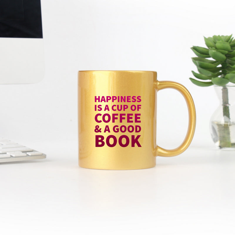 Elegant gold and silver ceramic mug with a motivational quote about coffee and books.