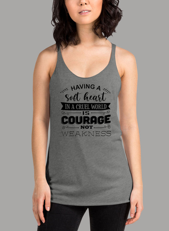 Black women's tank top with racer back style and curved hem, featuring the phrase 'Having A Soft Heart In A Cruel World'.