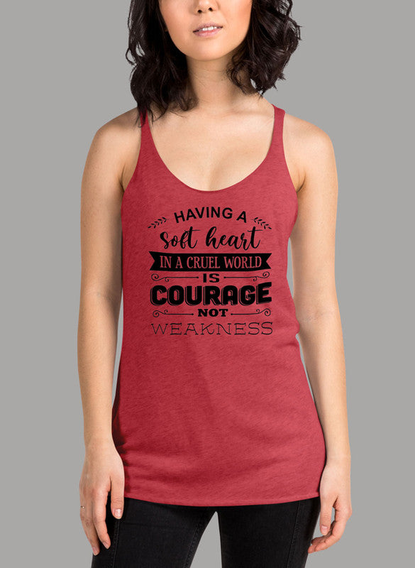 Black women's tank top with racer back style and curved hem, featuring the phrase 'Having A Soft Heart In A Cruel World'.