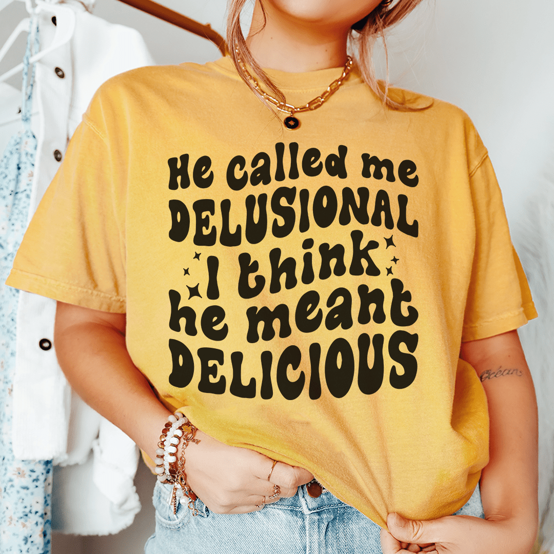 He Called Me Delusional I Think He Meant Delicious t-shirt displayed on a mannequin, showcasing its soft fabric and durable stitching.