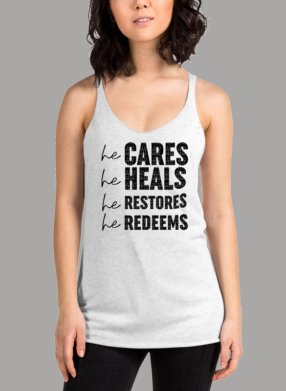 Black women's tank top featuring the phrase 'He Cares He Heals He Restores He Redeems' with a racer back design.