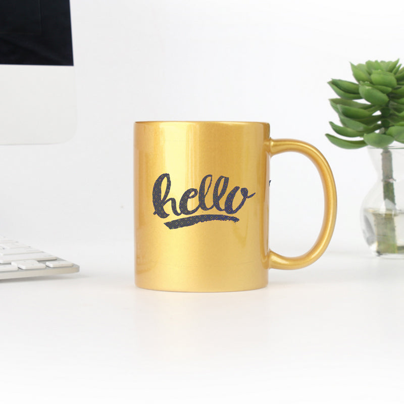 Hello Dots Yellow Hand Lettering Mug with gold and silver accents, showcasing a charming design on a ceramic surface.