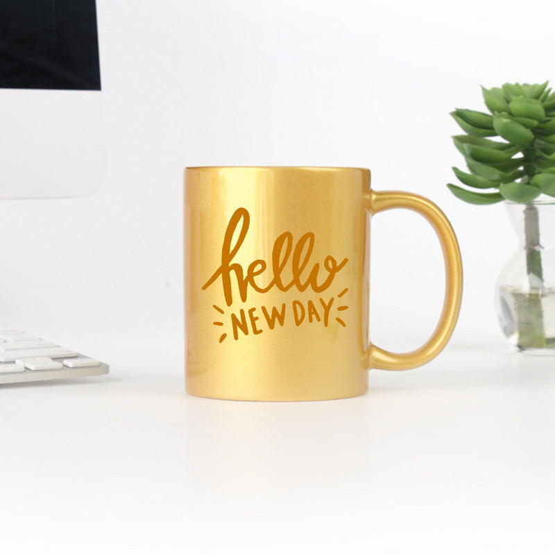 Ceramic mug featuring elegant gold and silver hand lettering, designed for stylish beverage enjoyment.