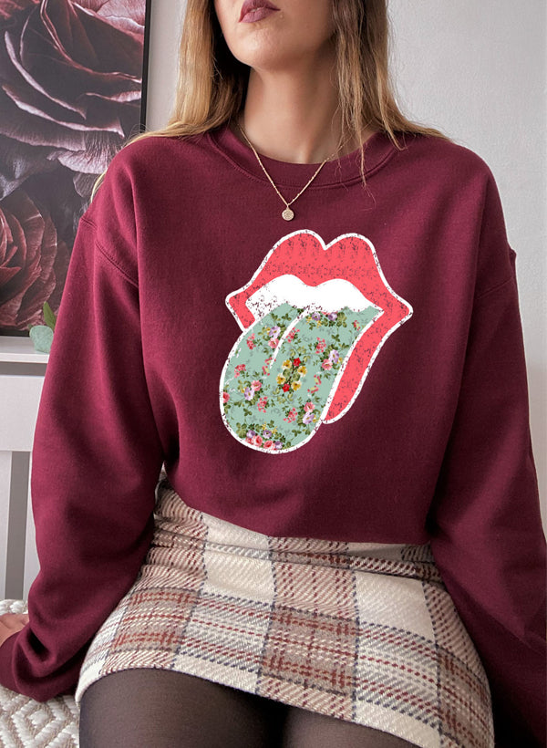 Hippie Floral Tongue Sweat Shirt featuring a vibrant floral design on a cozy fleece fabric.