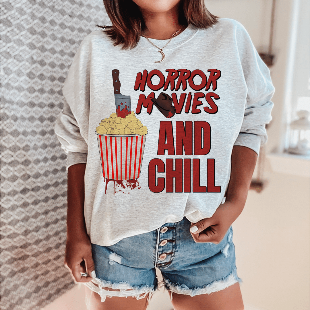 Cozy 'Horror Movies And Chill' sweats featuring unique horror-themed designs, made from a soft cotton/poly fleece blend.