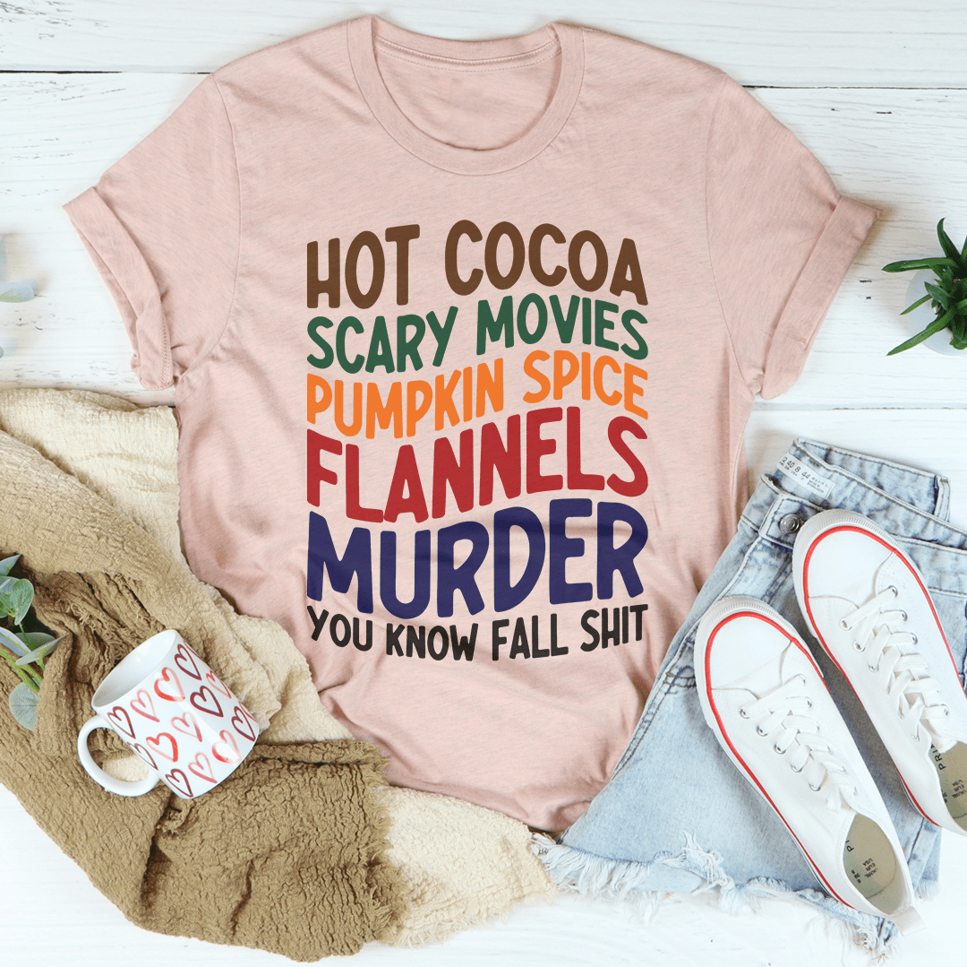 A cozy t-shirt featuring a fun design with hot cocoa, scary movies, and pumpkin spice themes, perfect for fall.