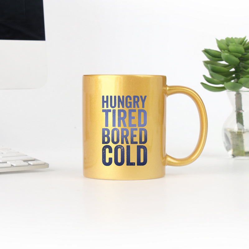 Hungry Tired Bored Cold Gold & Silver Mug with elegant metallic finish and ceramic body, perfect for beverages.