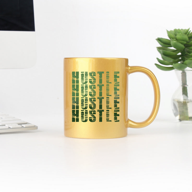 Hustle Gold & Silver Mug showcasing elegant gold metallic coating and ceramic design, perfect for stylish beverage enjoyment.