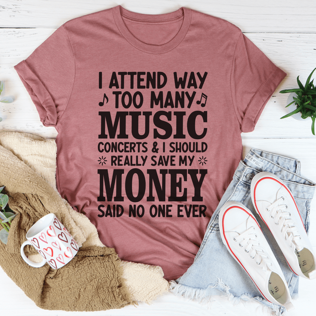 A stylish black t-shirt featuring the phrase 'I Attend Way Too Many Music Concerts' printed in vibrant colors, showcasing a love for music.