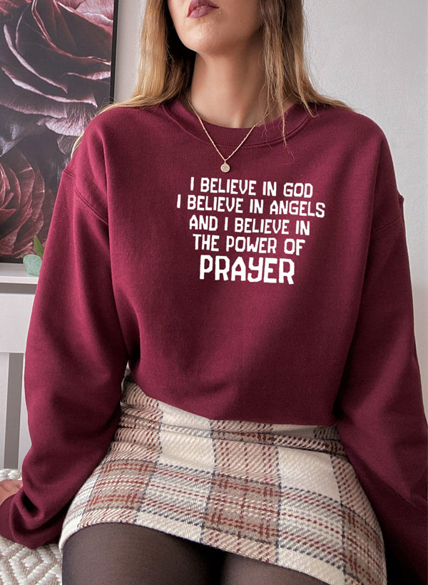 A cozy hoodie featuring the phrase 'I Believe In God I Believe In Angels' designed for comfort and style.