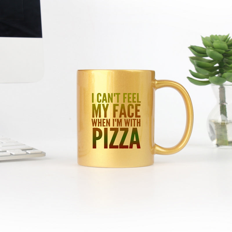 Ceramic mug with yellow gold and silver design featuring the phrase 'I Can't Feel My Face When I'm With Pizza'.