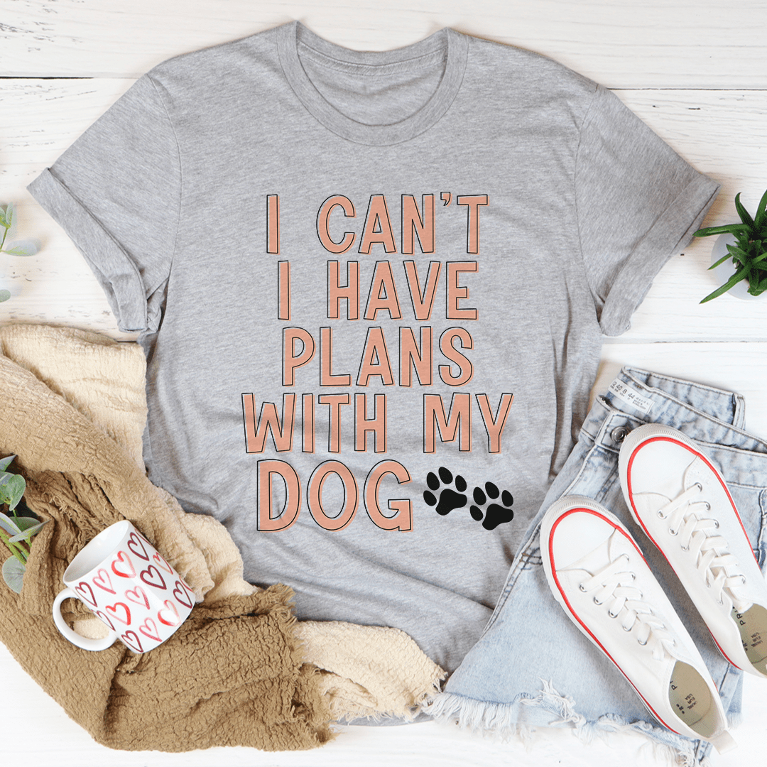 A stylish I Can't I Have Plans With My Dog Tee made from soft cotton, featuring a playful dog-themed slogan.