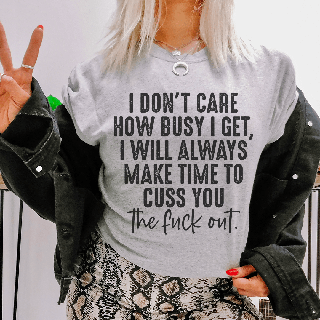 A stylish black t-shirt featuring the phrase 'I Don't Care How Busy I Get' printed in bold letters, showcasing its soft fabric and durable stitching.