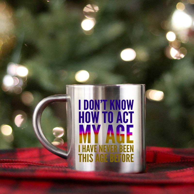 Gold ceramic mug with the phrase 'I Don't Know How To Act My Age' printed on it, showcasing a playful design.