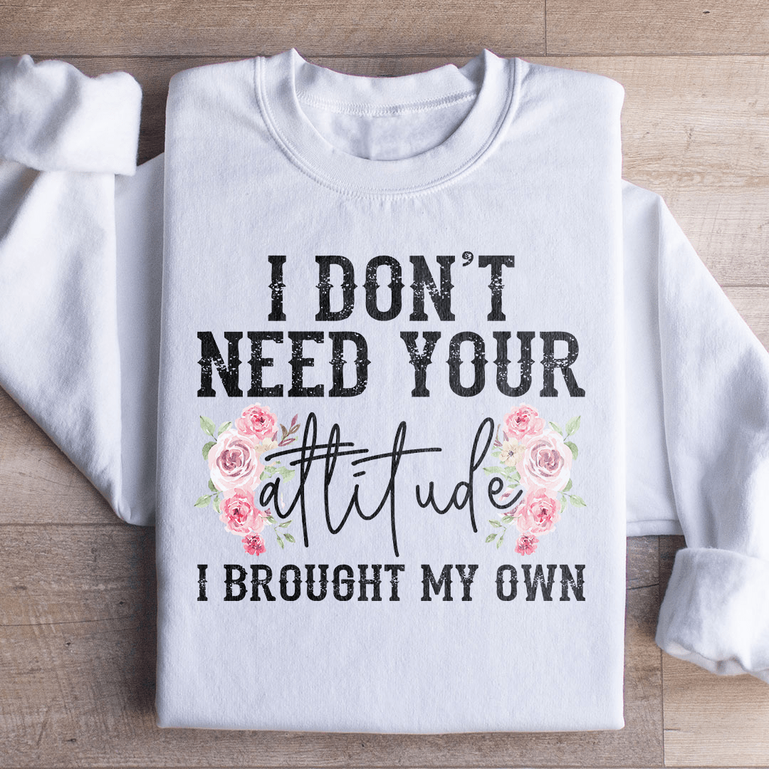 A cozy hoodie featuring the phrase 'I Don't Need Your Attitude I Brought My Own', designed by top artists, showcasing a stylish and comfortable fit.