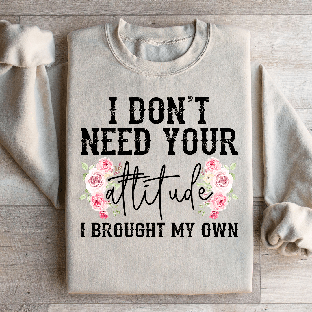 A cozy hoodie featuring the phrase 'I Don't Need Your Attitude I Brought My Own', designed by top artists, showcasing a stylish and comfortable fit.