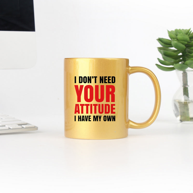 Ceramic gold and silver mug with humorous text, showcasing a stylish design.