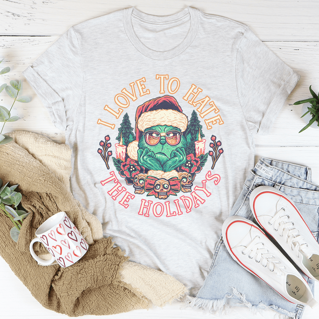 I Love To Hate The Holidays Tee, a comfortable and durable t-shirt made from soft ring-spun cotton, featuring double stitching for added durability.