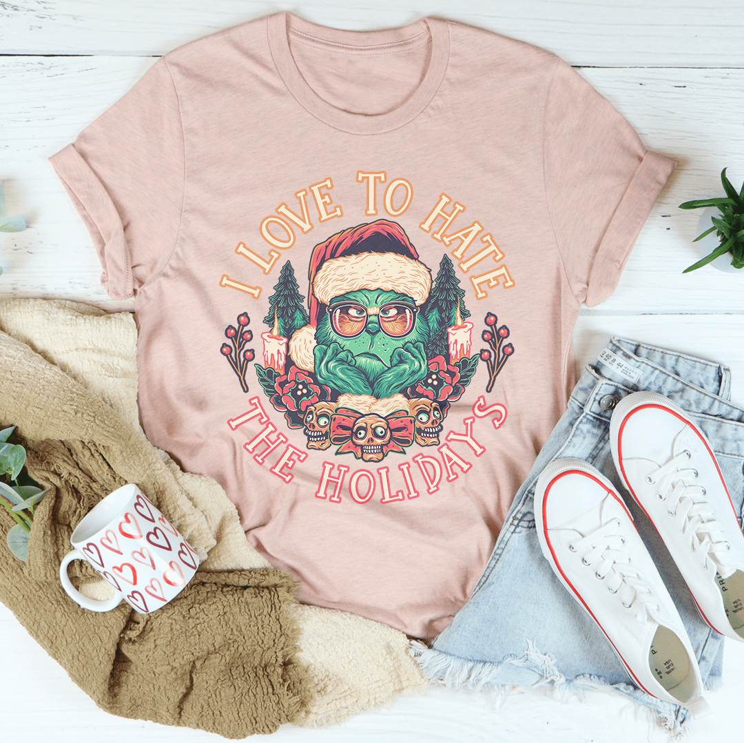 I Love To Hate The Holidays Tee, a comfortable and durable t-shirt made from soft ring-spun cotton, featuring double stitching for added durability.