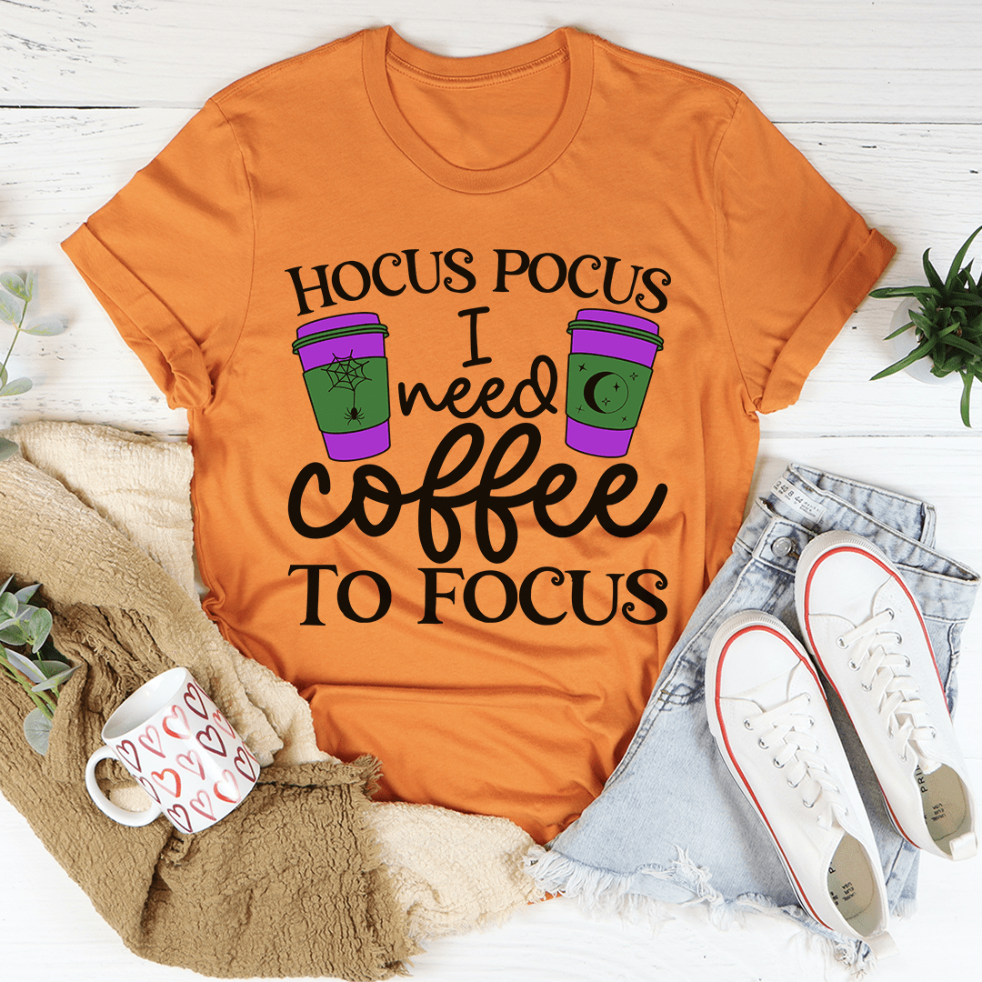 A comfortable 'I Need Coffee To Focus' T-Shirt made from soft ring-spun cotton, featuring a humorous coffee-themed design.