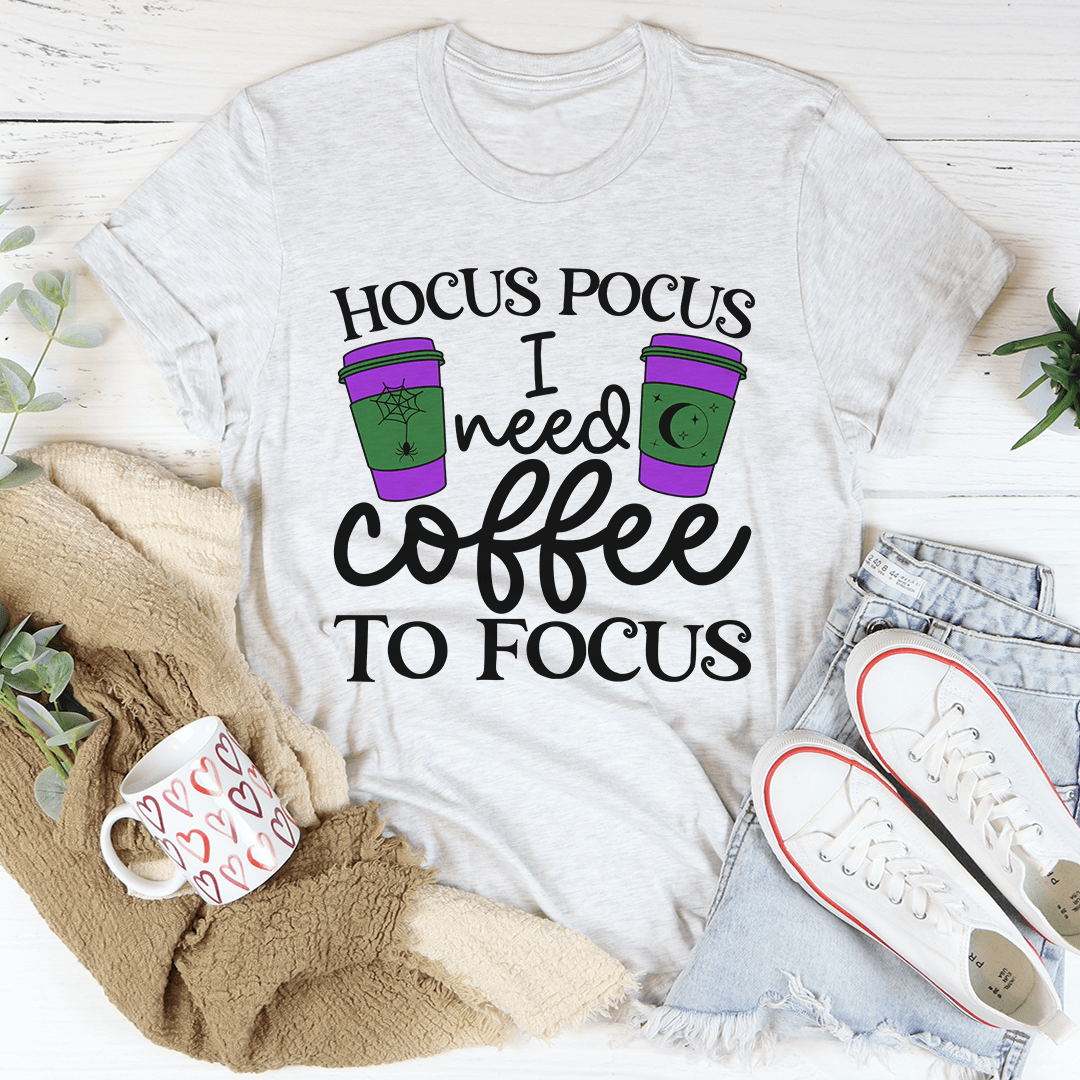 A comfortable 'I Need Coffee To Focus' T-Shirt made from soft ring-spun cotton, featuring a humorous coffee-themed design.