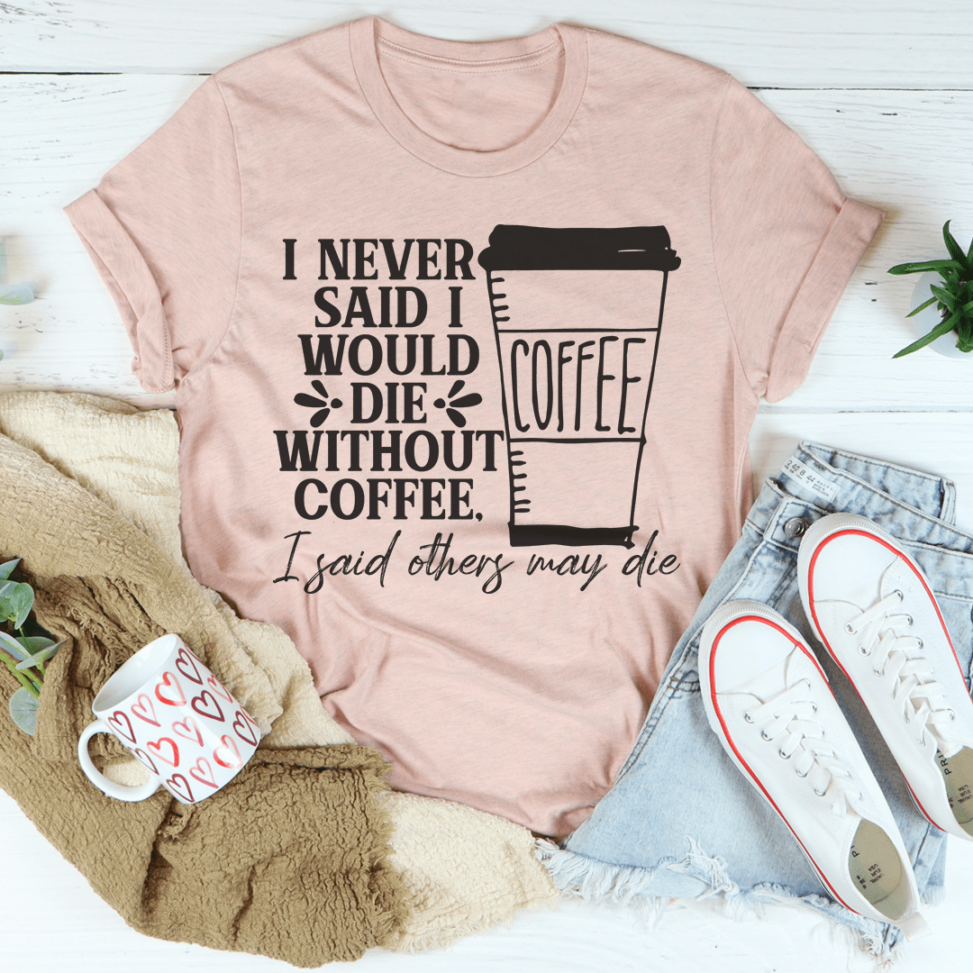 A stylish black t-shirt with the phrase 'I Never Said I Would Die Without Coffee' printed in white, showcasing its soft fabric and durable stitching.