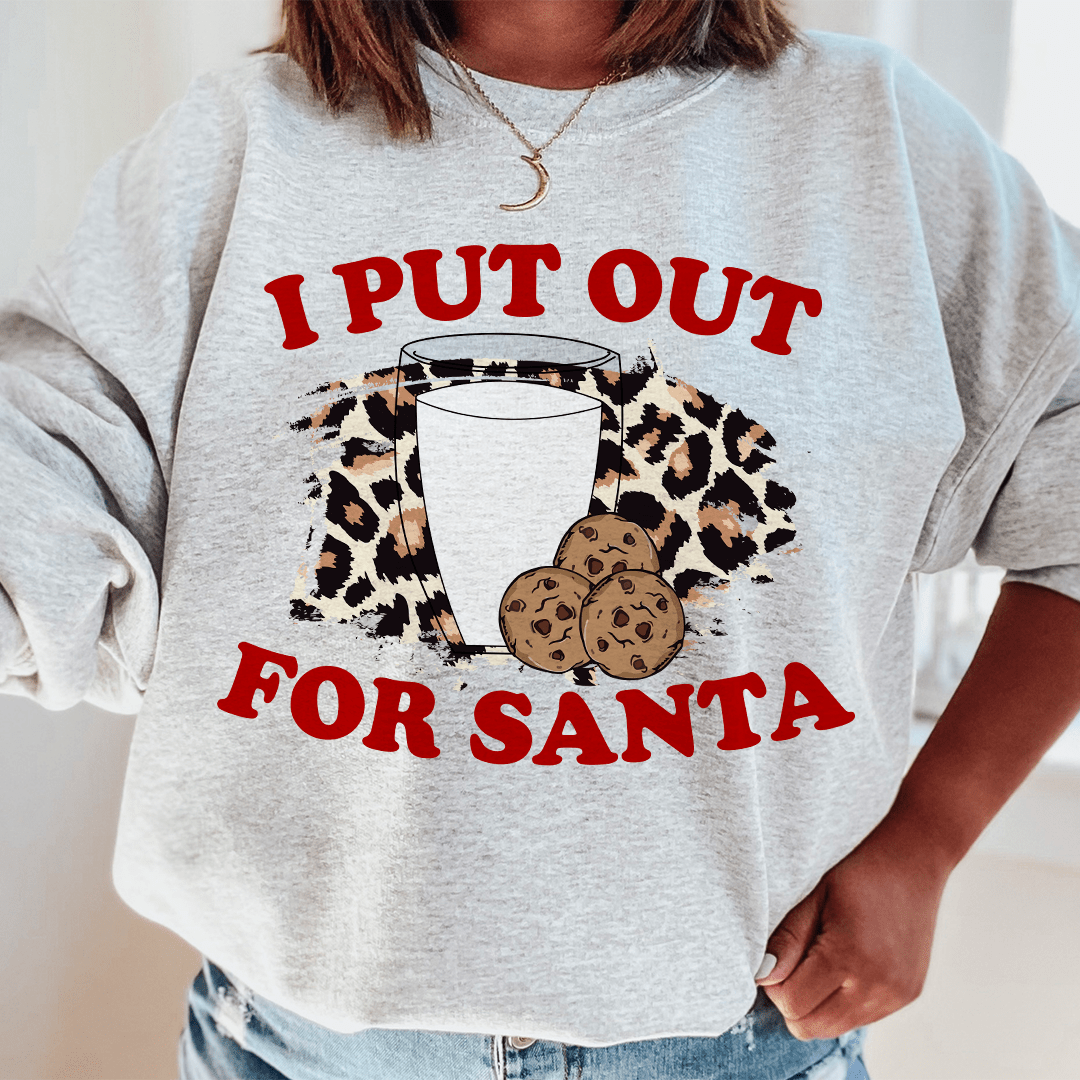 A cozy 'I Put Out For Santa' sweatshirt featuring a festive design, made from a soft cotton/poly fleece blend, perfect for holiday celebrations.